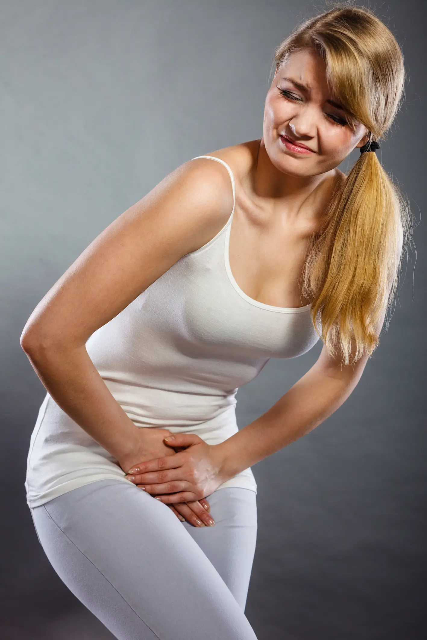 woman holds crotch area | obstetric and gynaecological ultrasound near me
